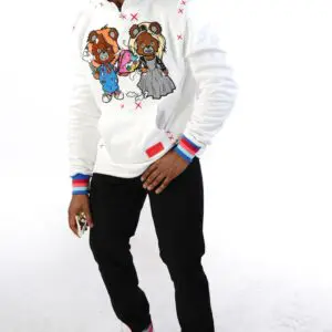 Person wearing a white sweatshirt with teddy bear graphics and black pants.