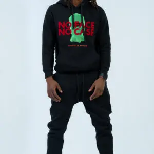 Man wearing a black hoodie and pants with a graphic design.