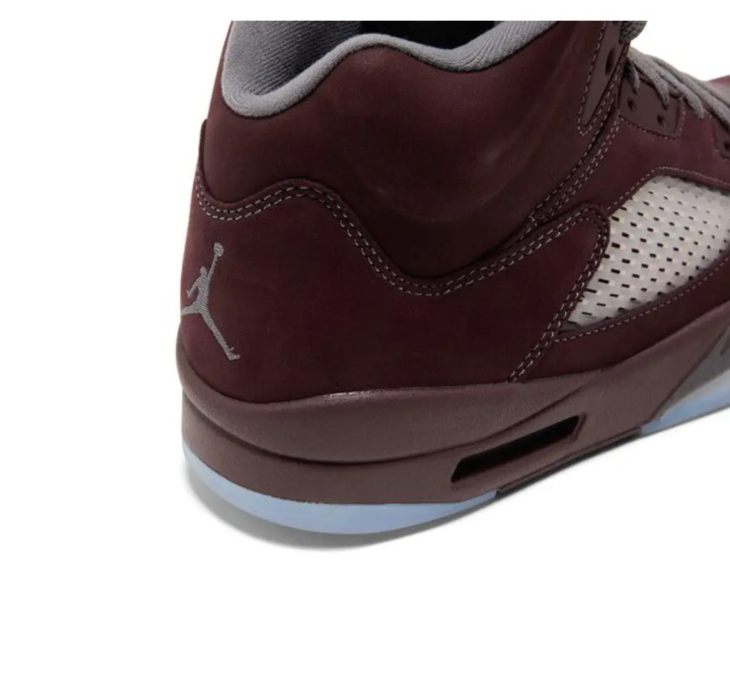 Close-up of a maroon and white sneaker with a visible Jumpman logo.