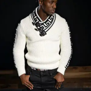 Man wearing a white textured sweater and patterned scarf.