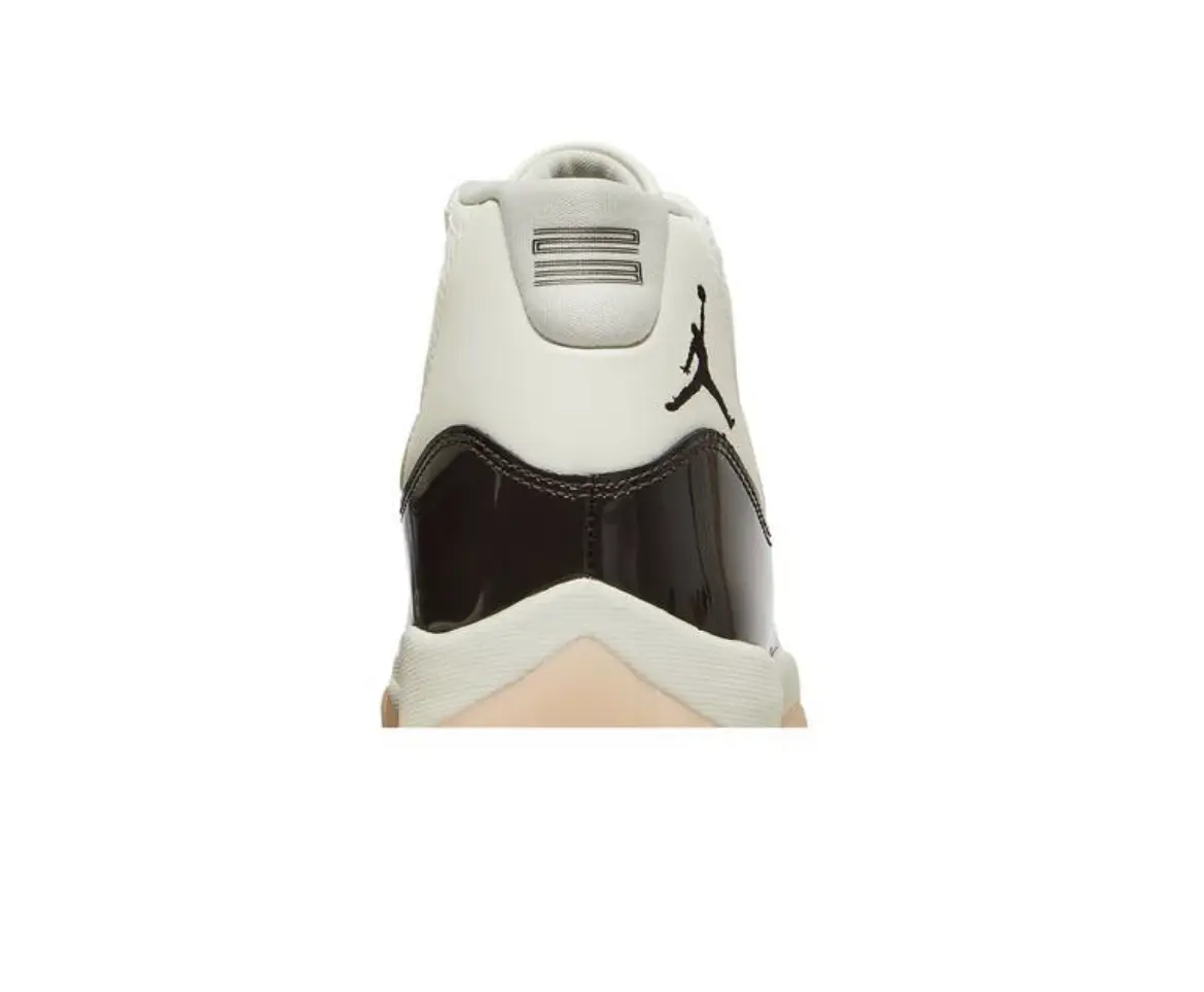 Back view of a white and black sneaker with a beige sole.
