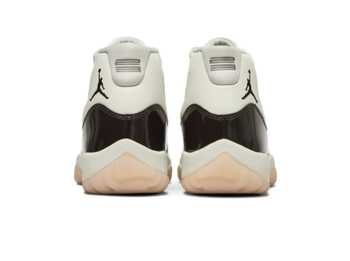 Rear view of white and black Air Jordan sneakers with gum soles.