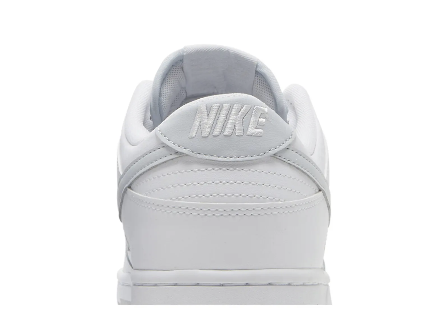 Rear view of a white Nike sneaker with embossed logo.