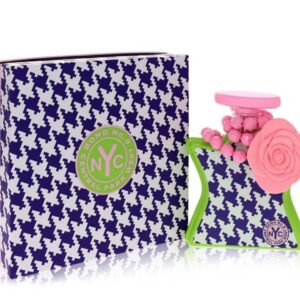 NYC perfume bottle with a decorative floral cap beside its patterned box.